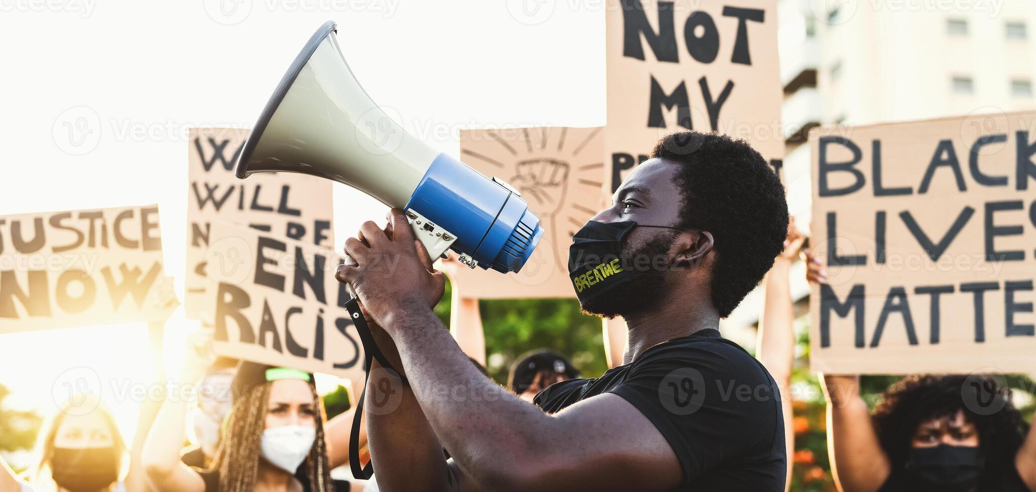 Activist movement protesting against racism and fighting for equality - Demonstrators from different cultures and race protest on street for equal rights - Black lives matter protests city concept photo