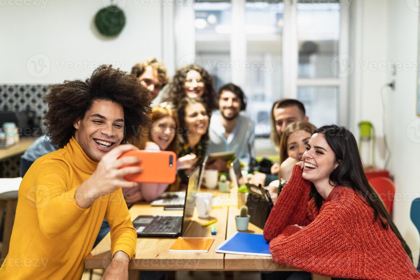 Young people taking selfie with mobile smartphone in co-working creative space - Youth millennial generation and business technology concept photo