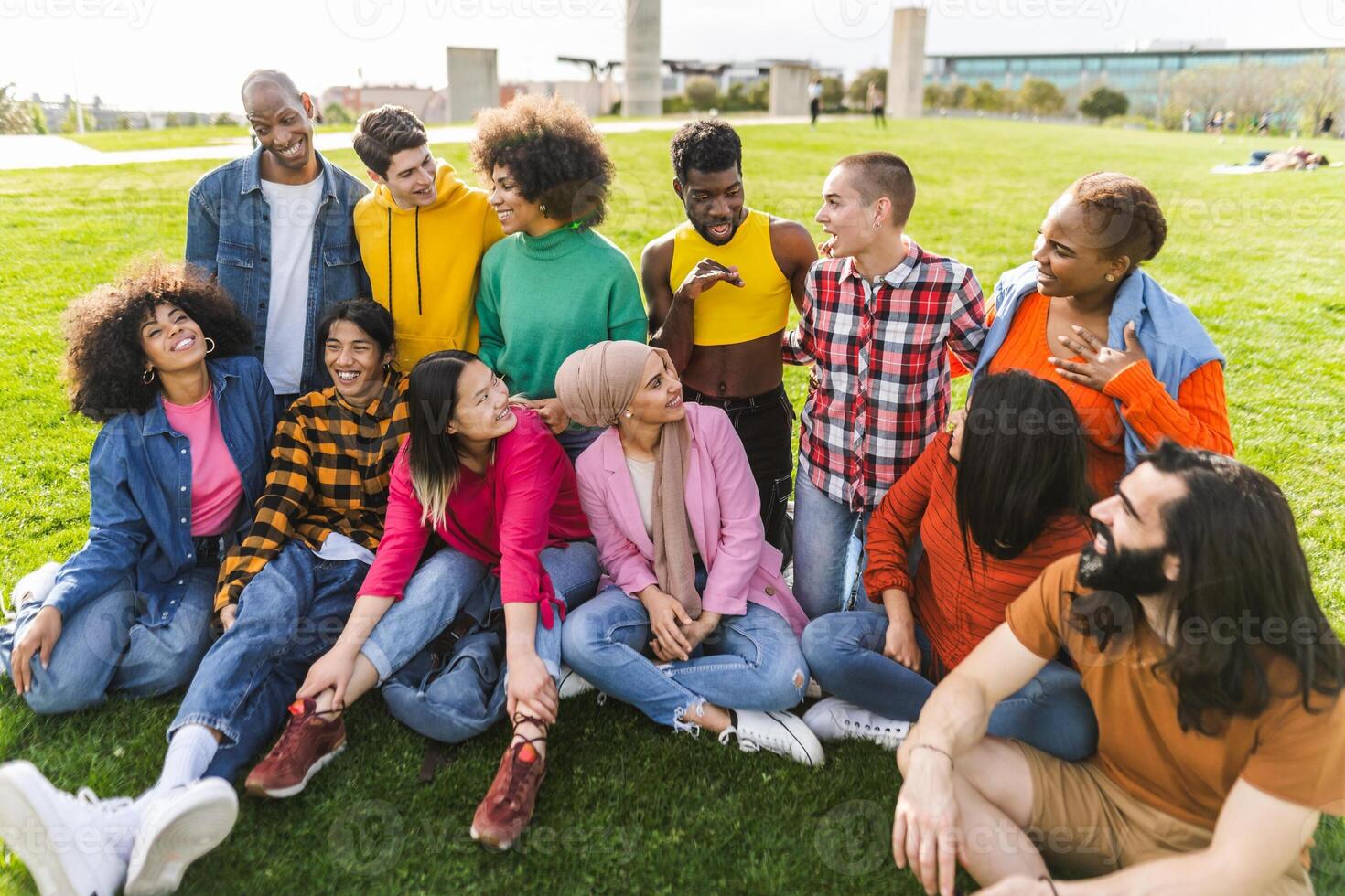 Group of young multiracial friends having fun together in park - Friendship and diversity concept photo