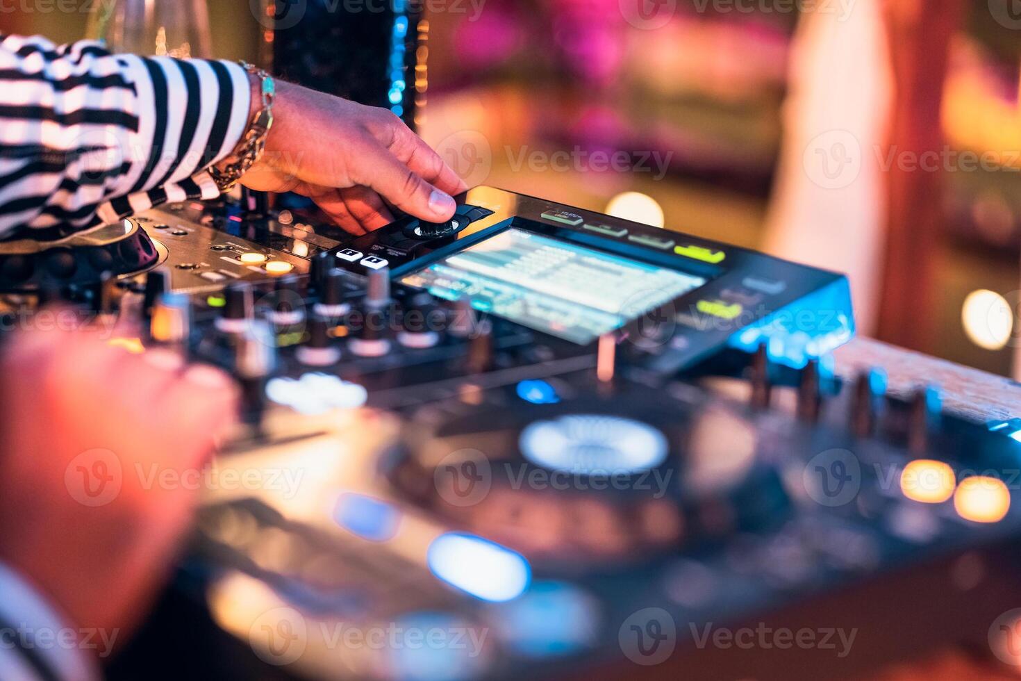 Close up dj hand mixing music at cocktail bar - Party nightlife concept photo