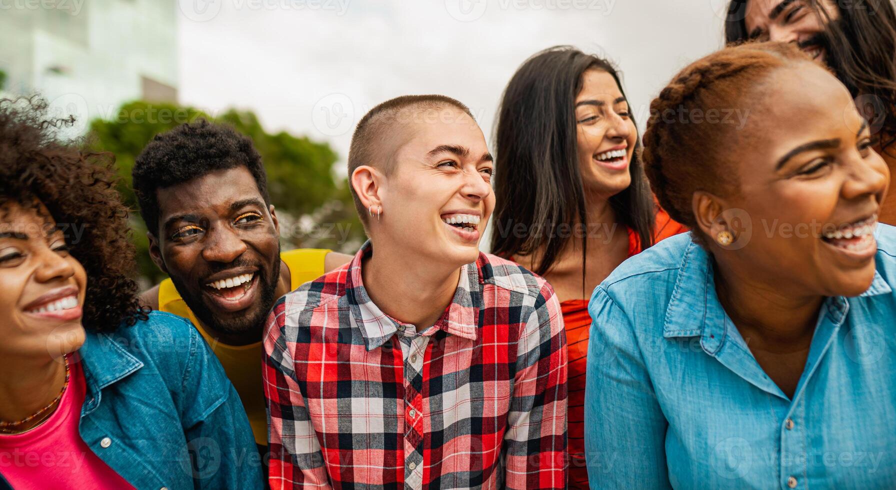 Young multi ethnic friends having fun together hanging out in the city - Friendship and diversity concept photo