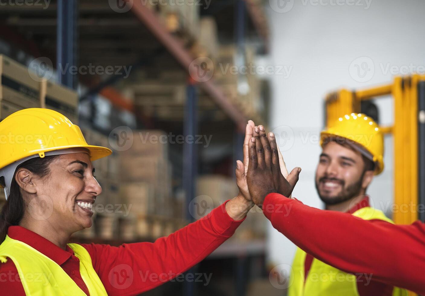 Happy team enjoying working together in delivery warehouse - Logistic and industrial concept photo