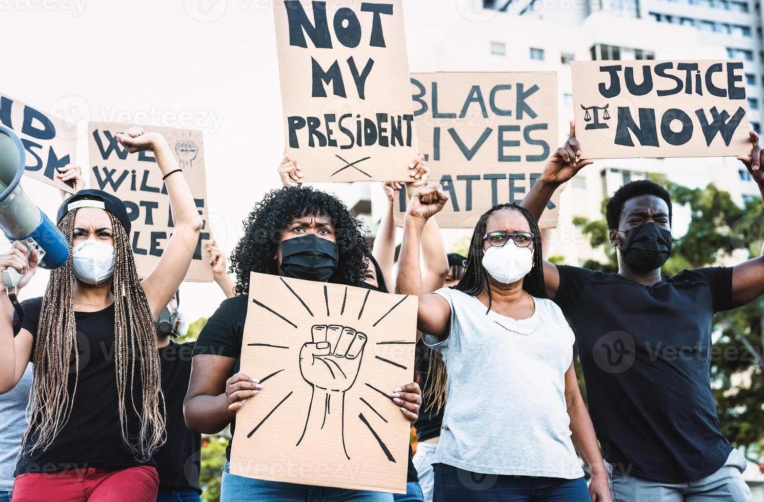 Black lives matter activist movement protesting against racism and fighting for equality - Demonstrators from different cultures and race protest on street for justice and equal rights photo