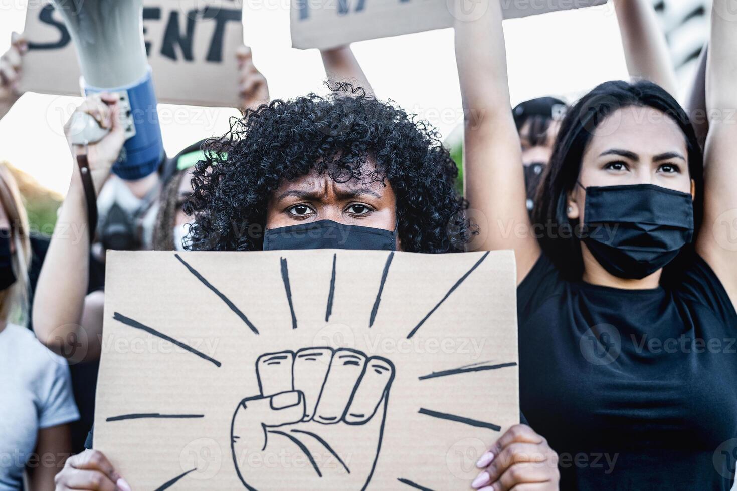 Black lives matter international activist movement protesting against racism and fighting for justice - Demonstrators from different cultures and race protest on street for equal rights photo