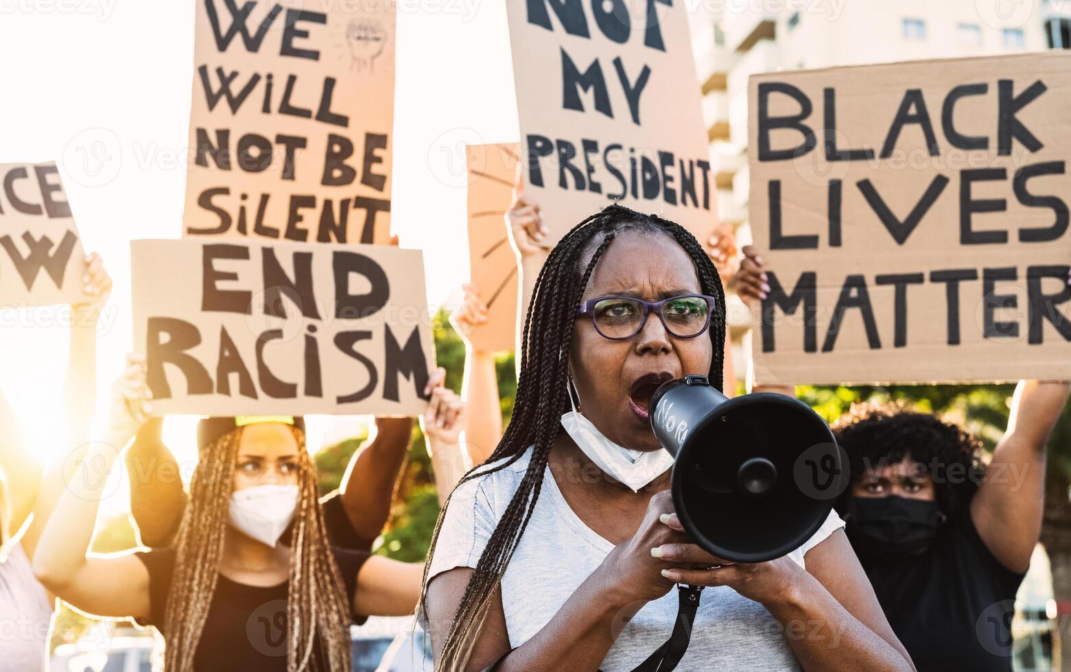 Activist movement protesting against racism and fighting for equality - Demonstrators from different age and race manifesting for equal rights - Black lives matter street city protests concept photo