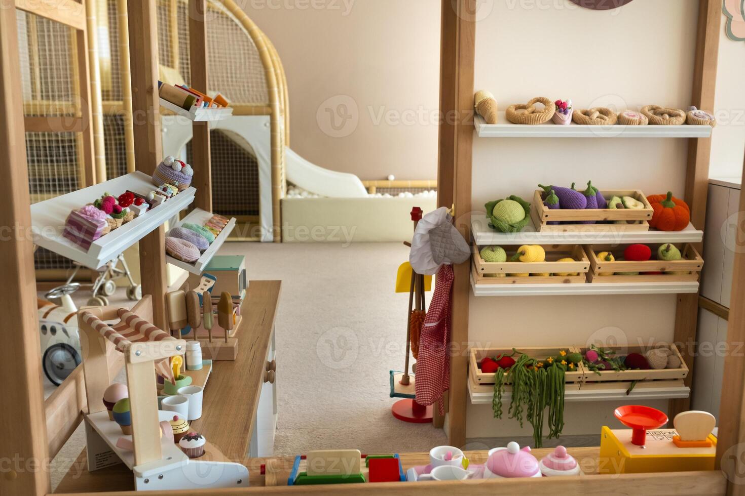 Wooden children's play kitchen with dishes and artificial food photo