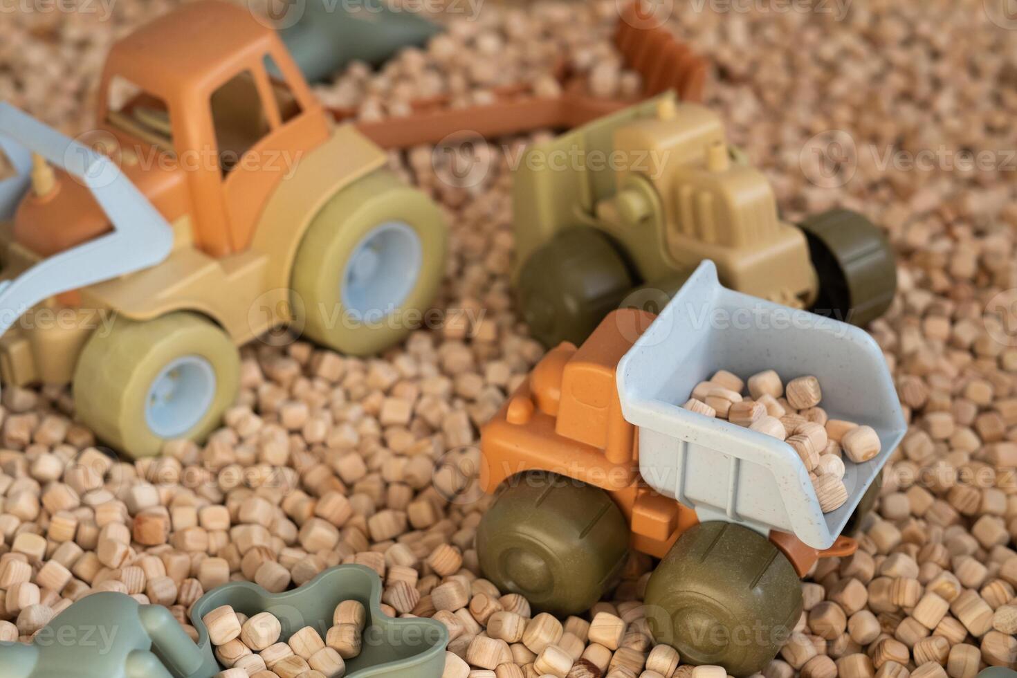 A modern children's sandbox with toys. Sandbox filler in the form of wooden small wooden cubes photo