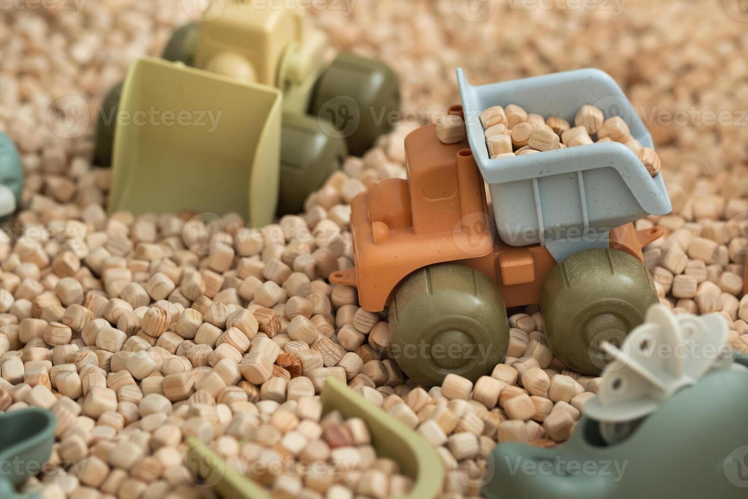 A modern children's sandbox with toys. Sandbox filler in the form of wooden small wooden cubes photo