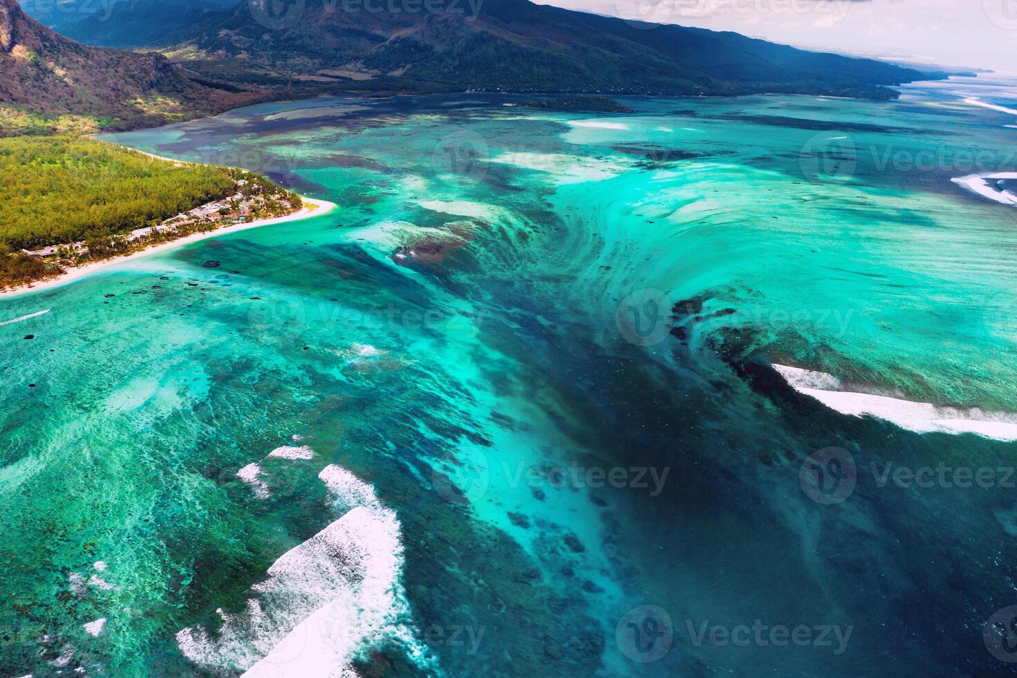 The view from the bird's eye view of the coral reef near the mountain Le Morne Brabant, a beautiful blue lagoon and the underwater waterfall photo