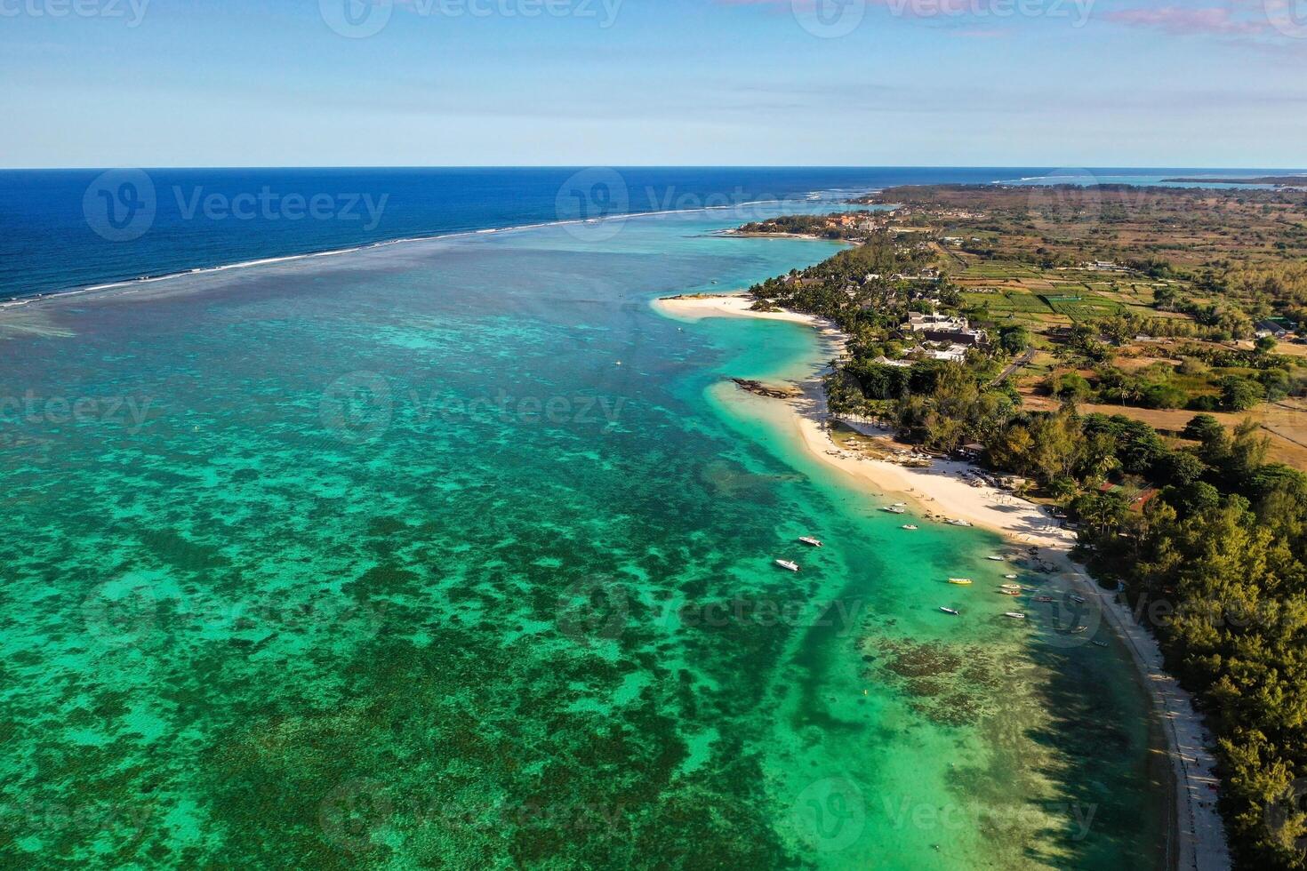 View from the height of the east coast of the island of Mauritius. Flying over the turquoise lagoon of the island of Mauritius in the area of Bel Mare. photo