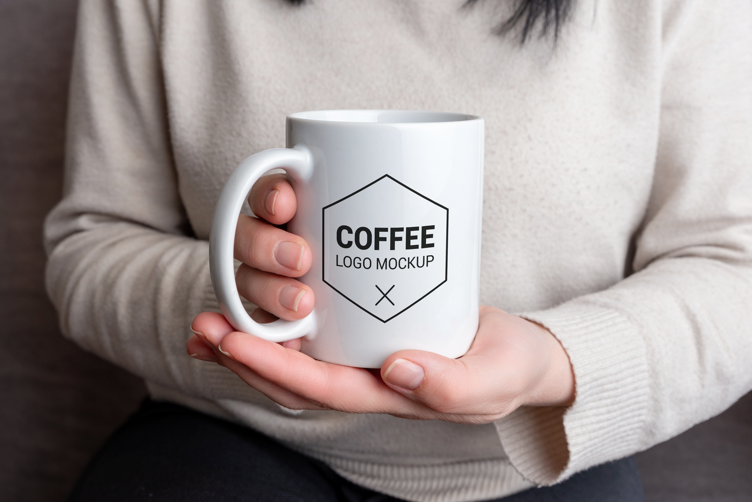 White mug in female hands with logo mockup psd