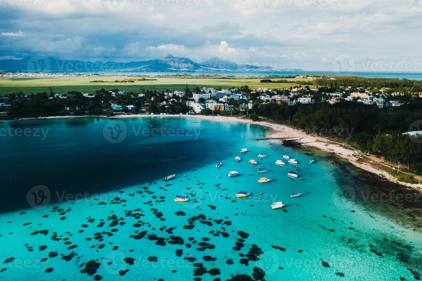 Aerial picture of the east coast of Mauritius Island. Beautiful lagoon of Mauritius Island shot from above. Boat sailing in turquoise lagoon photo