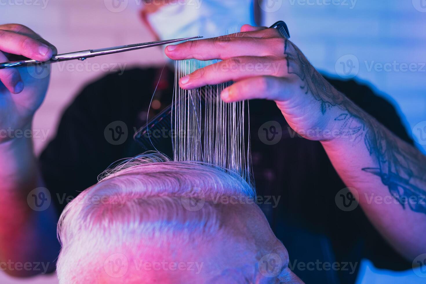 Male hairdresser cutting hair to hipster senior client while wearing face surgical mask - Young hairstylist working in barbershop during corona virus outbreak - Health care and haircut salon concept photo