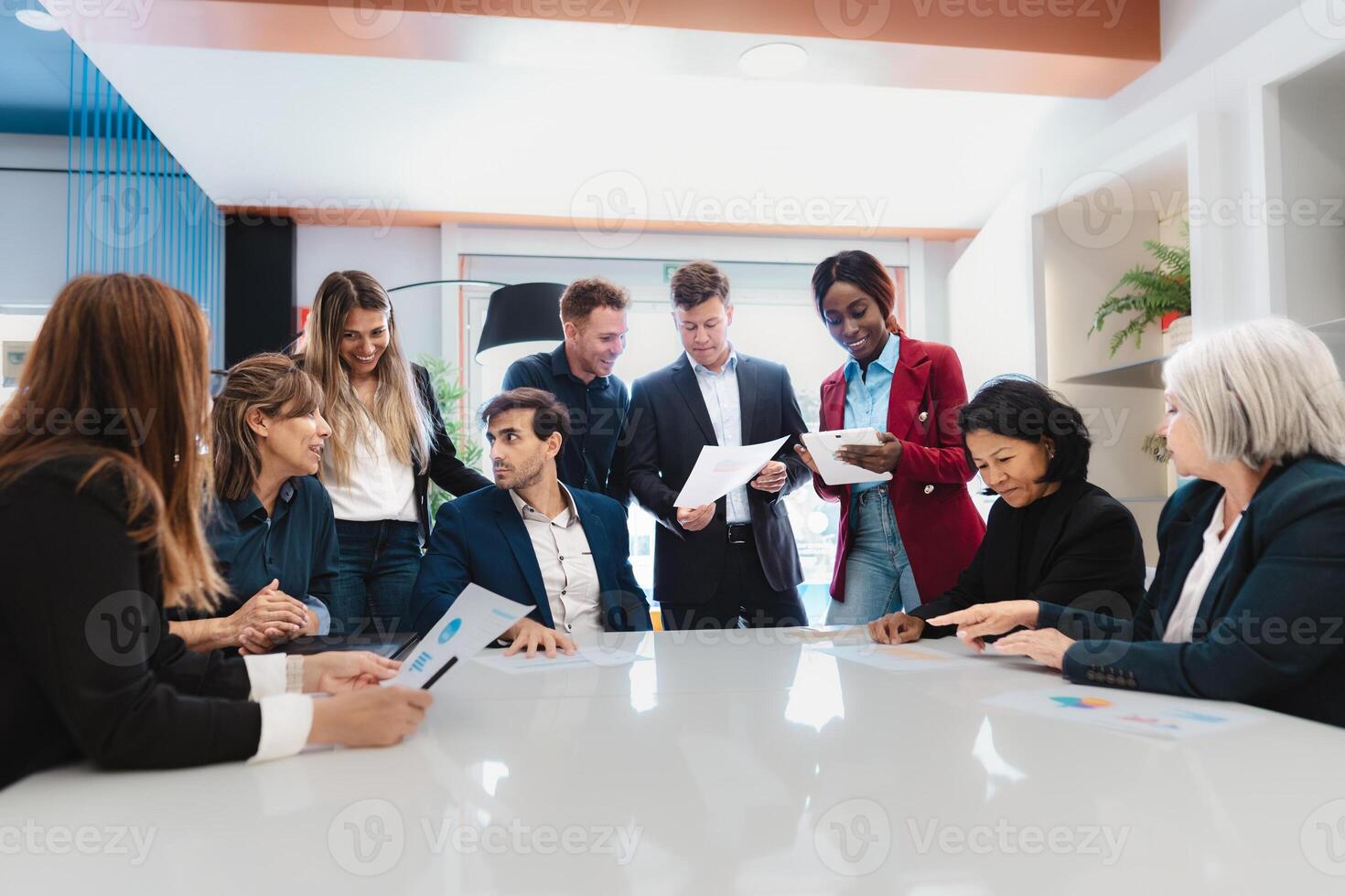 Multiracial business team working together in a boardroom of modern office - Entrepreneurship concept photo