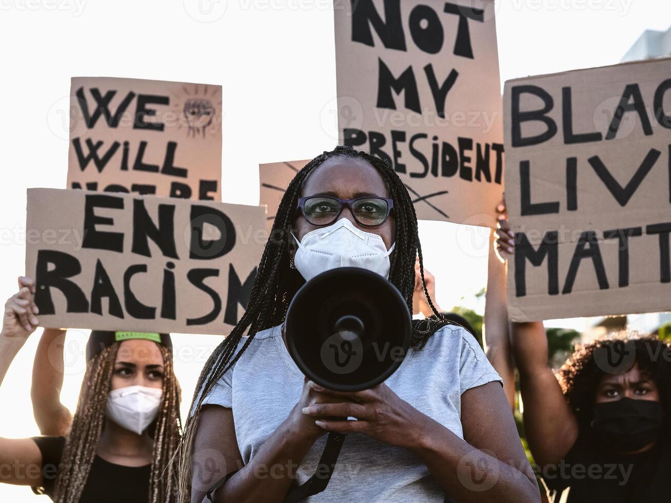 Activist movement protesting against racism and fighting for equality - Demonstrators from different cultures and race protest on street for equal rights - Black lives matter protests city concept photo