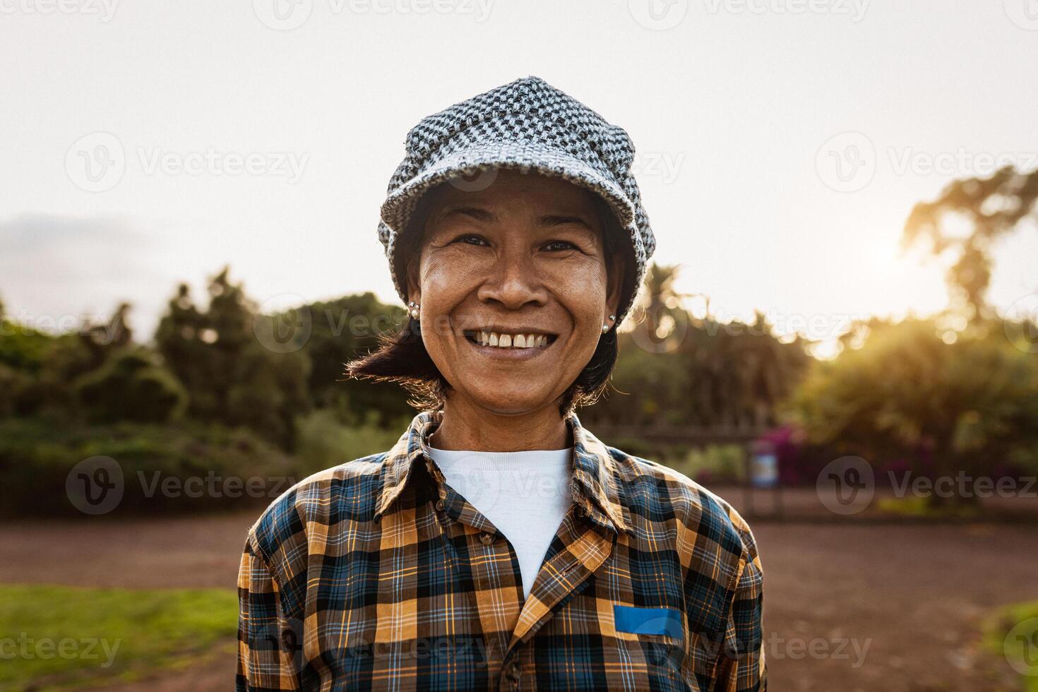 Happy Southeast Asian woman having fun smiling on camera in a public park photo