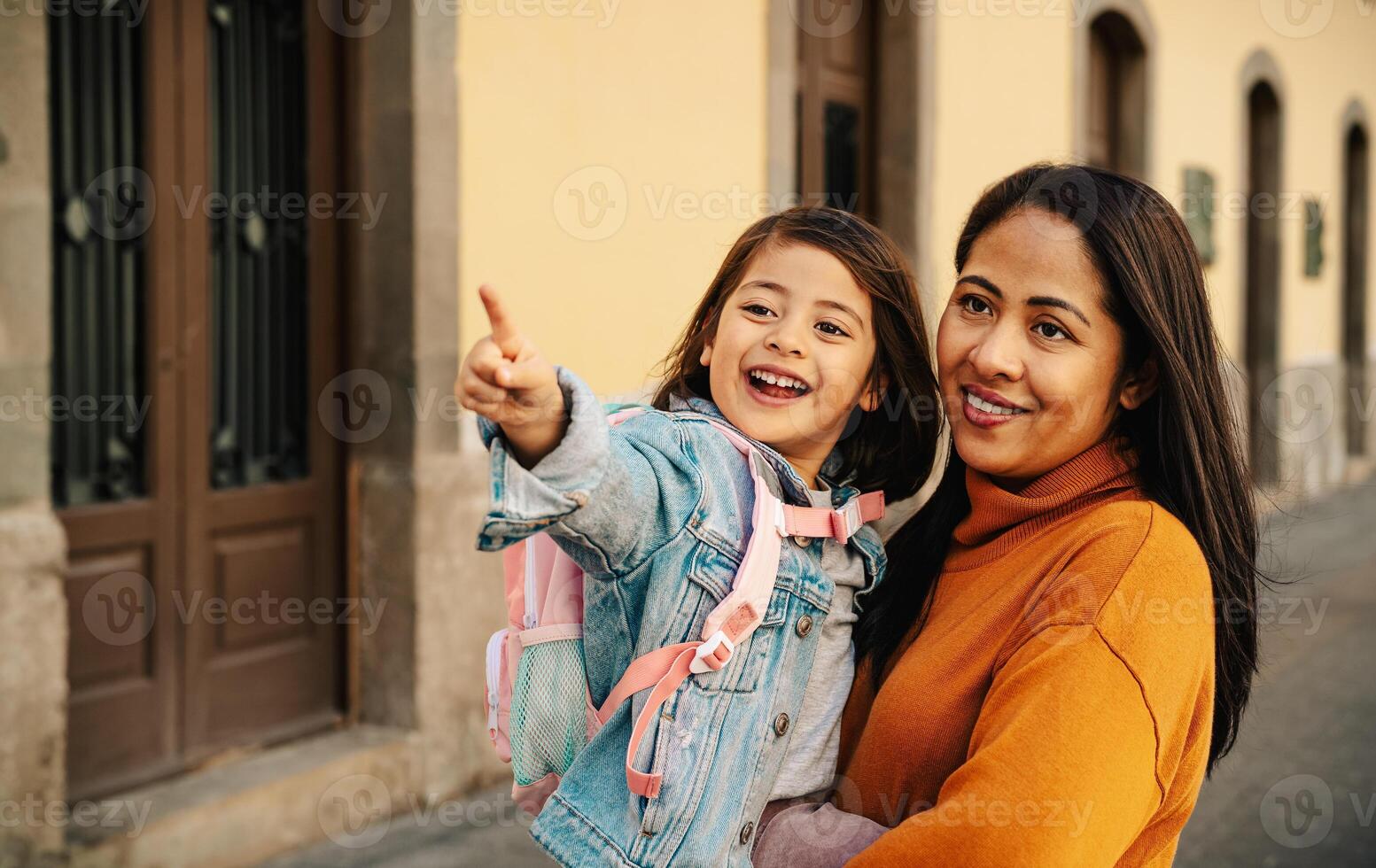 Happy filipina mother bringing her daughter at school - Biracial family concept photo