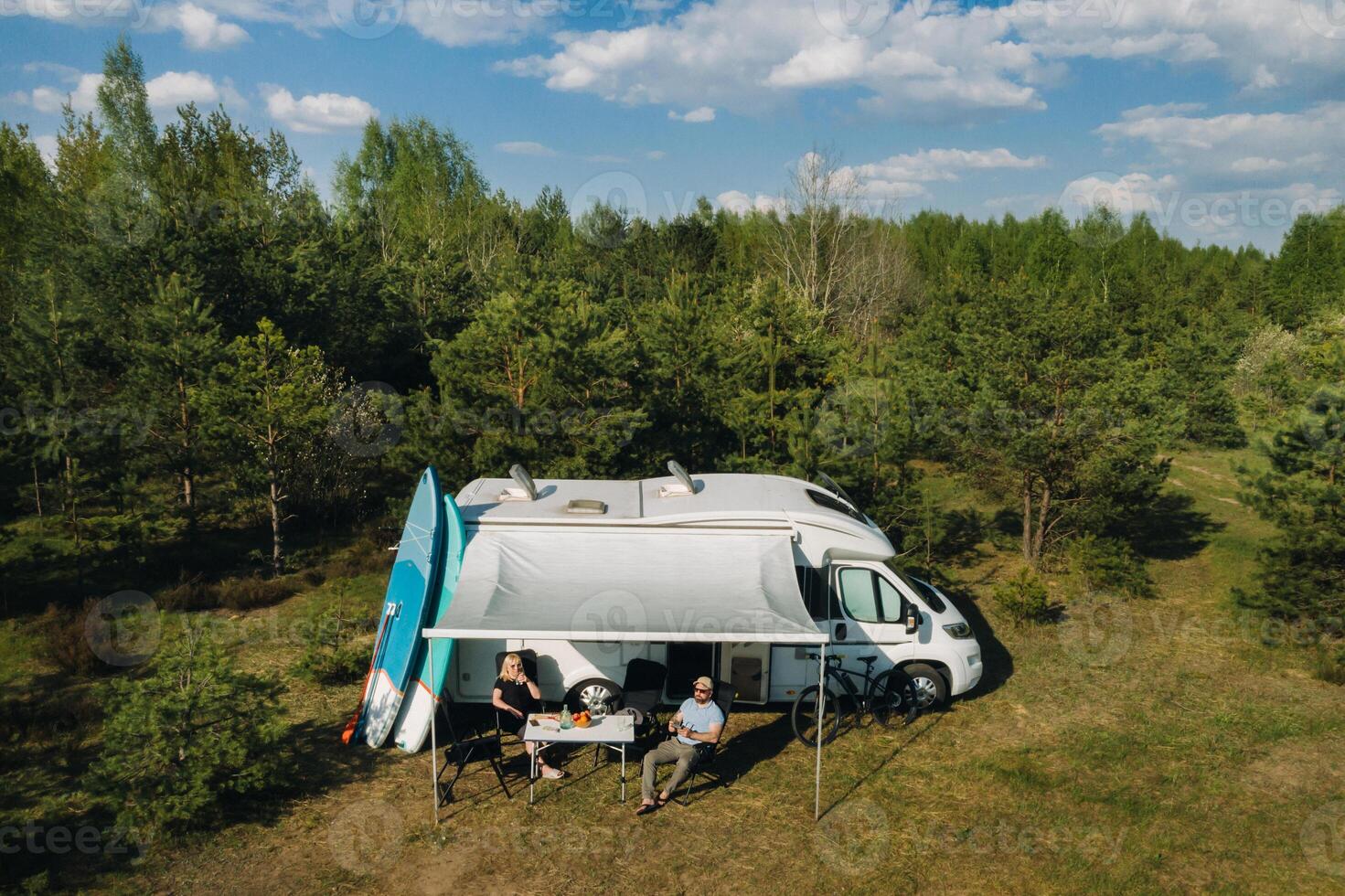 The family is resting in their race track located in the forest in sunny weather photo