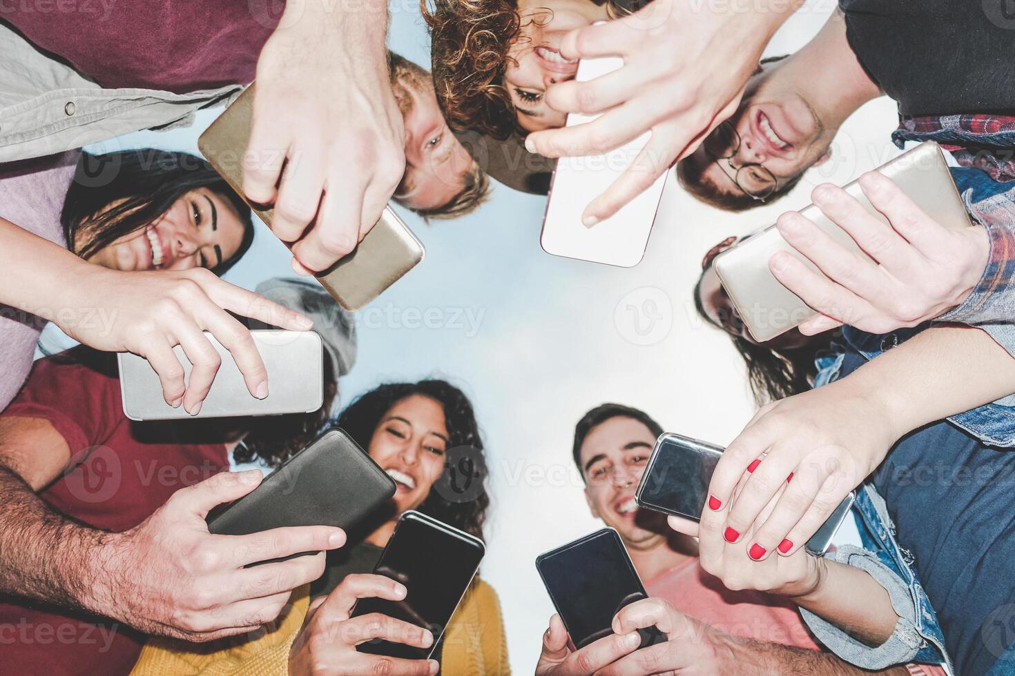 Group of friends using mobile smartphones outdoor - Millennial young people addicted to new technology trends - Concept of millennials generation z, tech, social media network and youth lifestyle photo