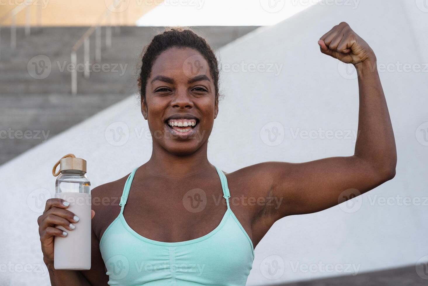 Young African woman taking a break during workout exercises outdoor - Sport people lifestyle concept photo