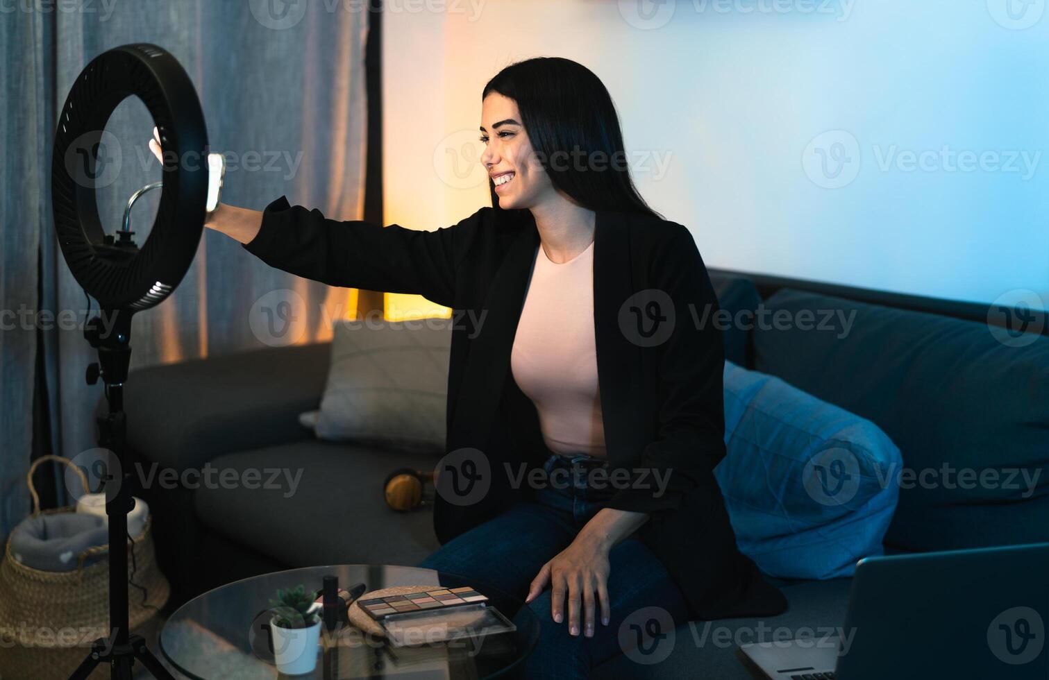 Young woman vlogging online with smartphone cam and ring led from home - Youth people with social media and smart working concept photo