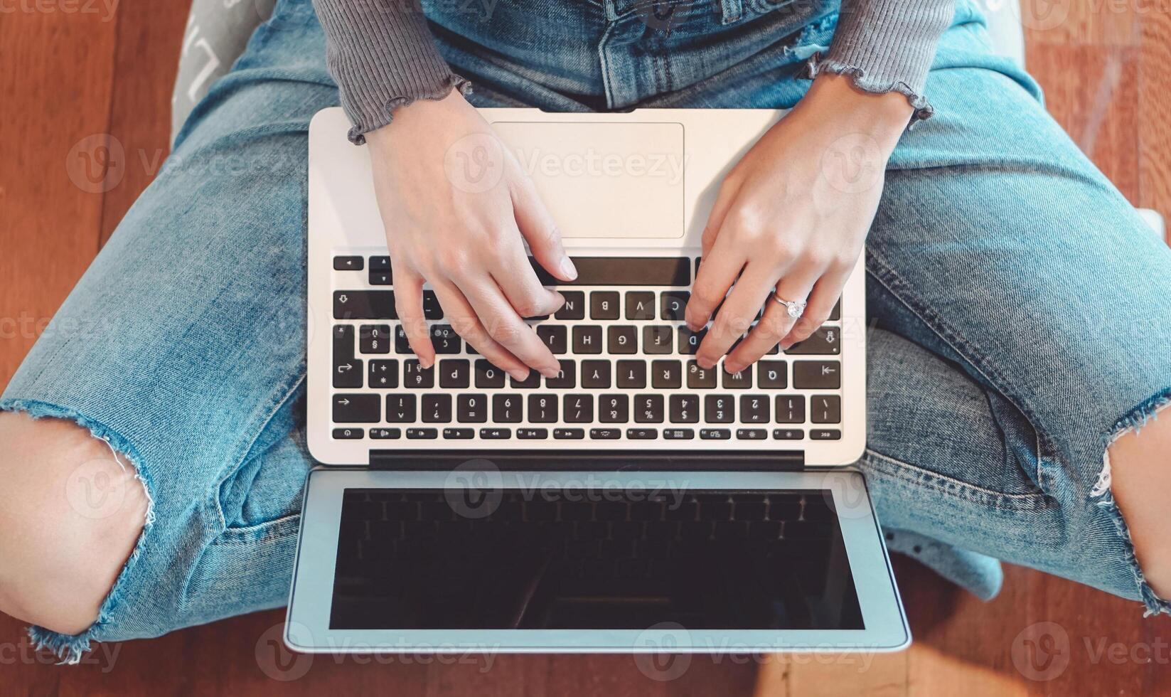 Young girl using laptop at home - Woman having fun with new technology computer while sitting on the floor - People, youth , tech and work concept photo