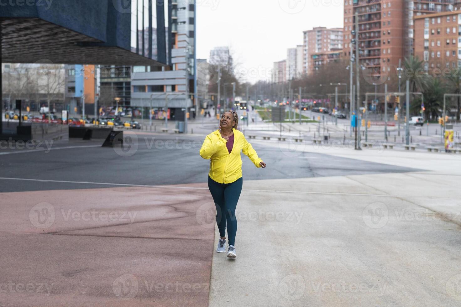 African senior woman running in the city - Elderly Sporty people lifestyle concept photo