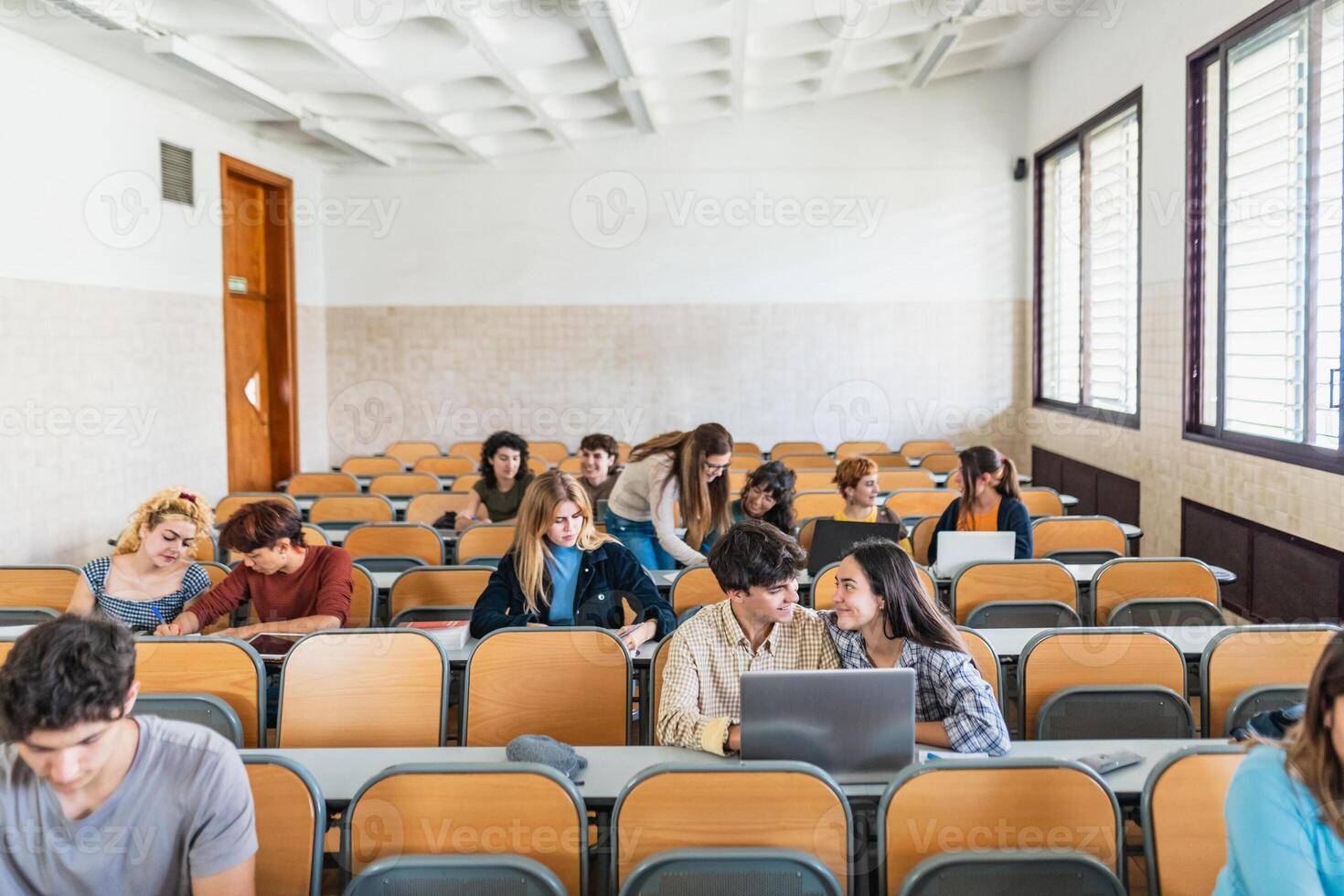 Young people studying inside university classroom - Education concept photo