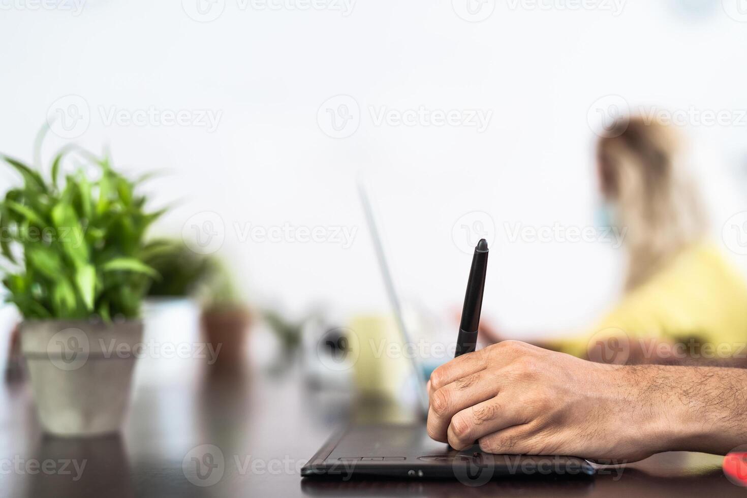 Close up male hand working in co-working creative space keeping social distance - New measures for workers and technology concept photo