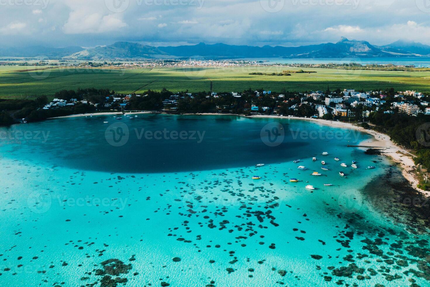 Aerial picture of the east coast of Mauritius Island. Beautiful lagoon of Mauritius Island shot from above. Boat sailing in turquoise lagoon photo