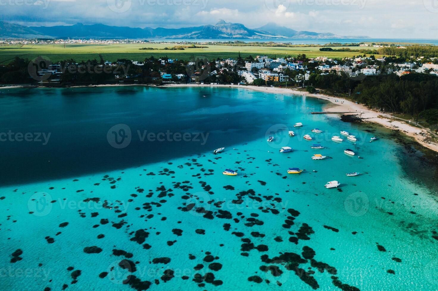 Aerial picture of the east coast of Mauritius Island. Beautiful lagoon of Mauritius Island shot from above. Boat sailing in turquoise lagoon photo