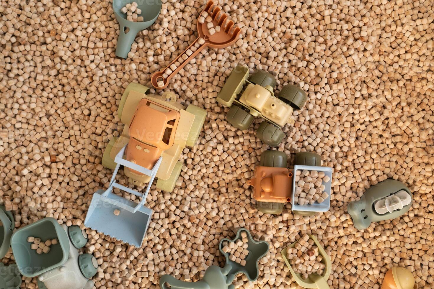 A modern children's sandbox with toys. Sandbox filler in the form of wooden small wooden cubes photo