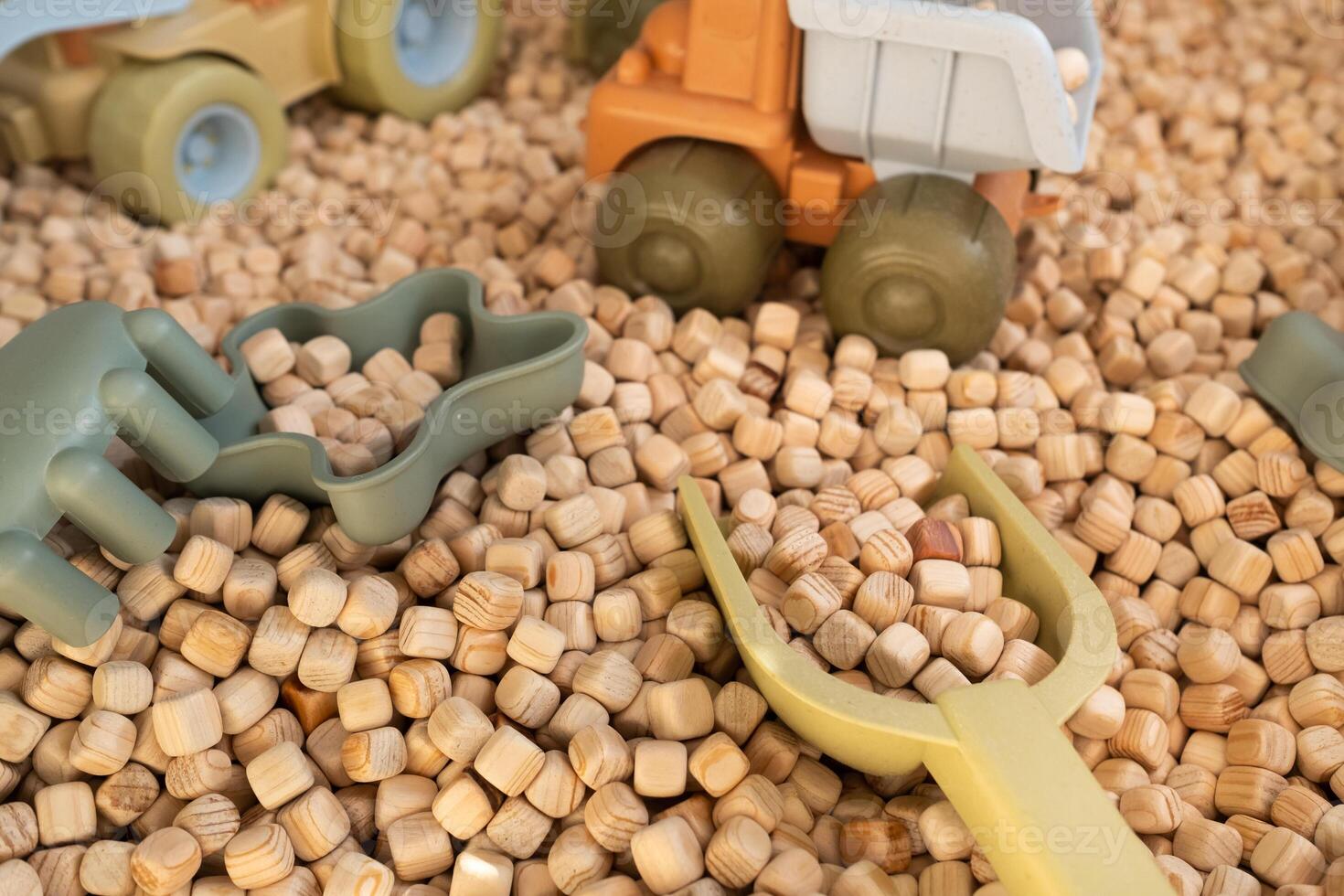 A modern children's sandbox with toys. Sandbox filler in the form of wooden small wooden cubes photo