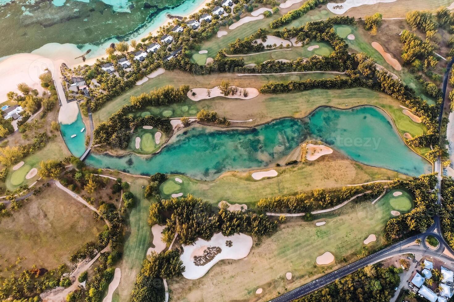 View from the height of the island of Mauritius in the Indian Ocean and the golf course on the Le Morne peninsula photo