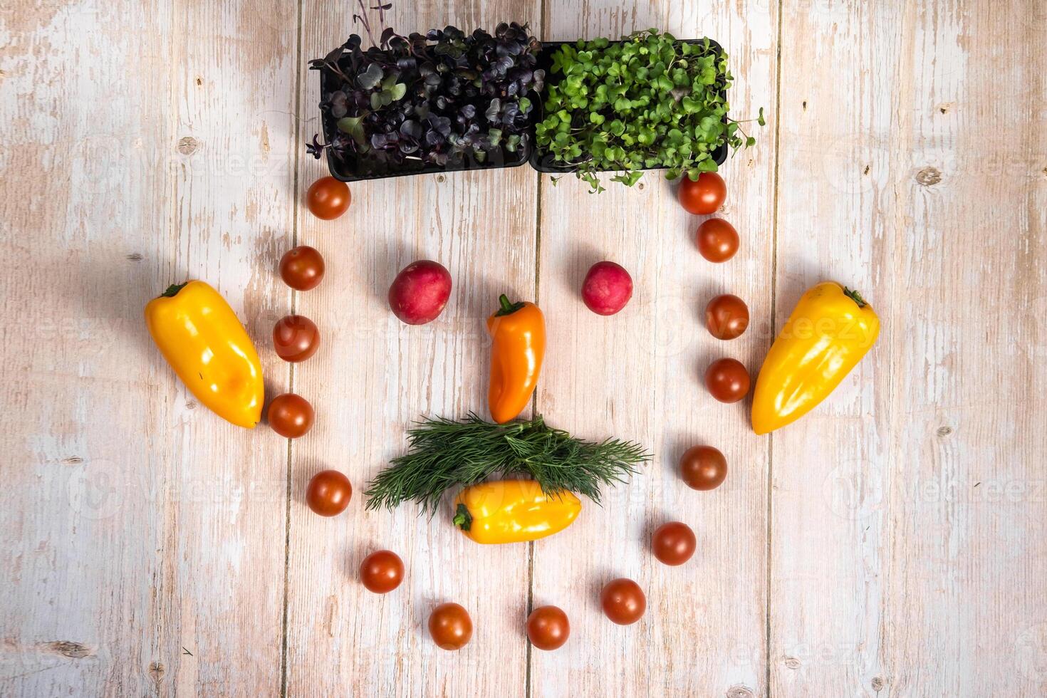 The face of a man made of sliced vegetables on a wooden background photo