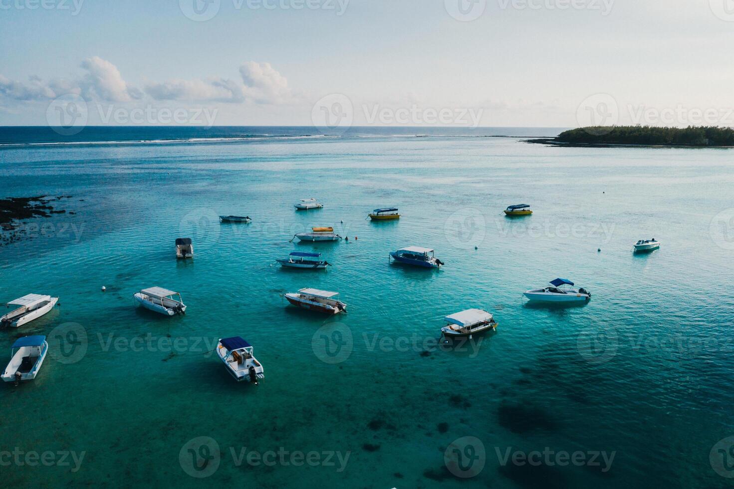 Aerial picture of the east coast of Mauritius Island. Beautiful lagoon of Mauritius Island shot from above. Boat sailing in turquoise lagoon photo