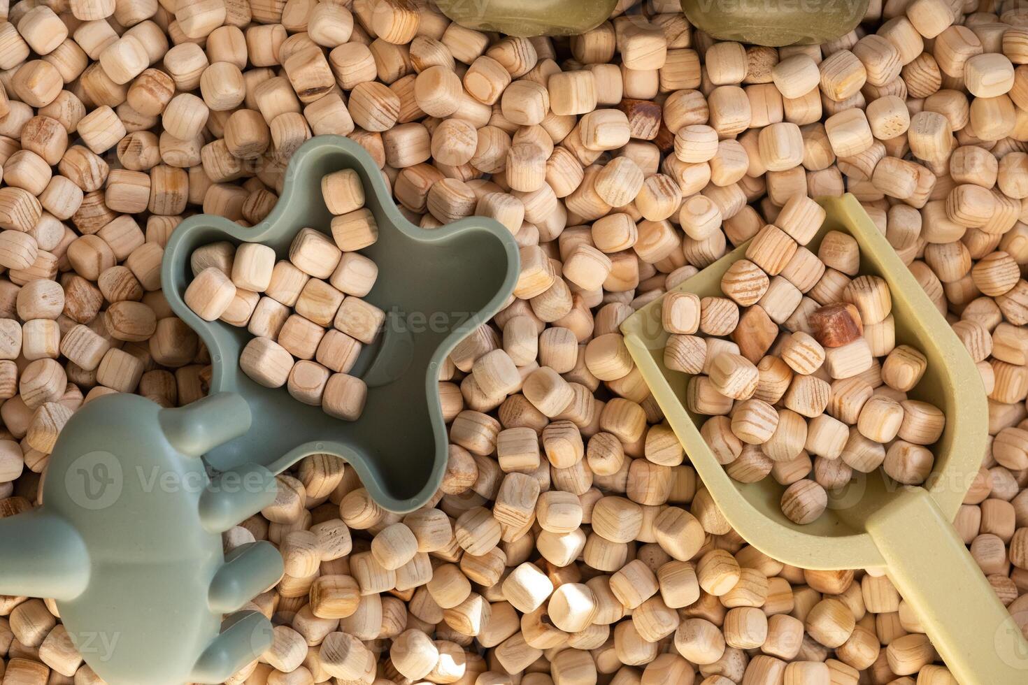 A modern children's sandbox with toys. Sandbox filler in the form of wooden small wooden cubes photo