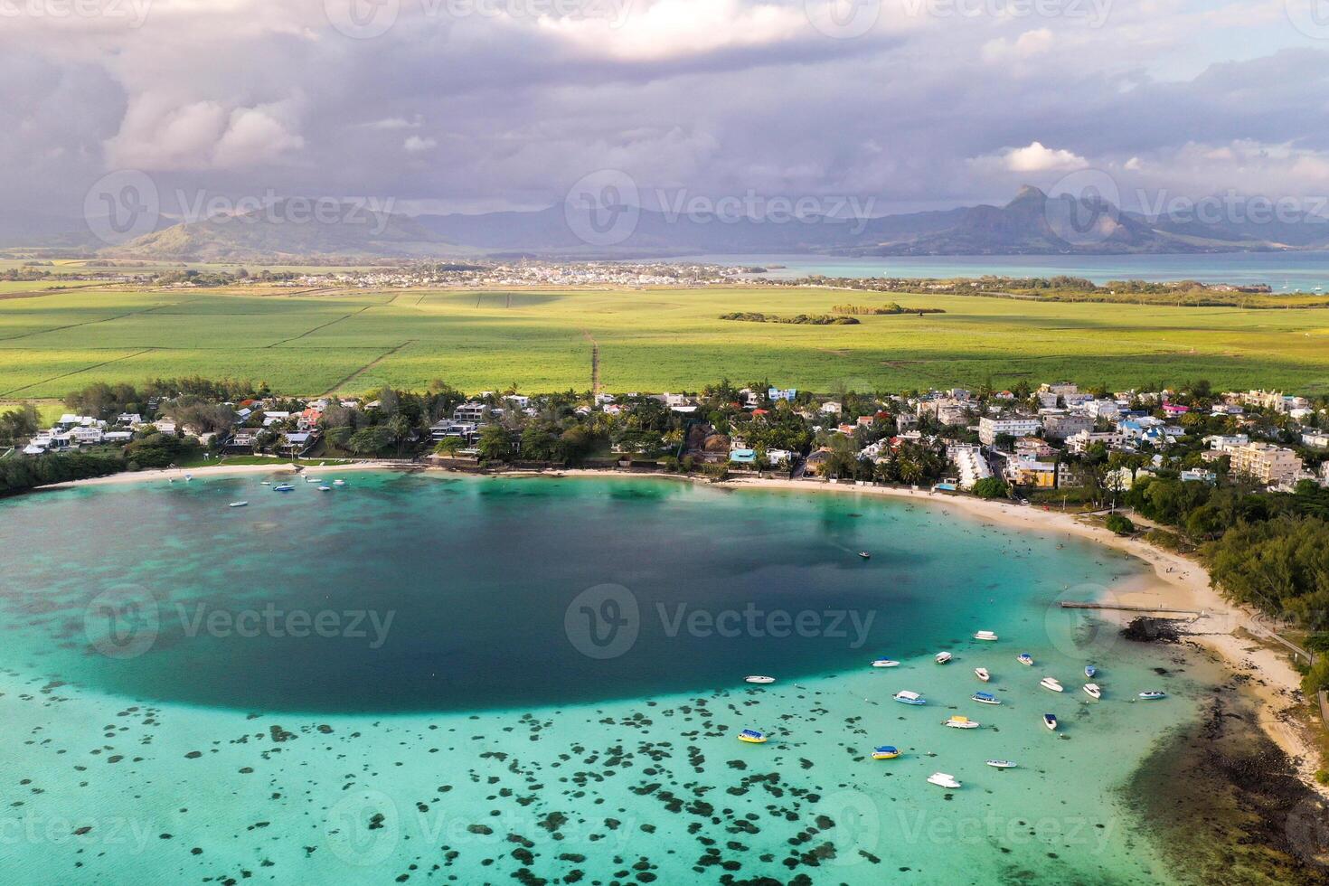 Aerial picture of the east coast of Mauritius Island. Beautiful lagoon of Mauritius Island shot from above. Boat sailing in turquoise lagoon photo