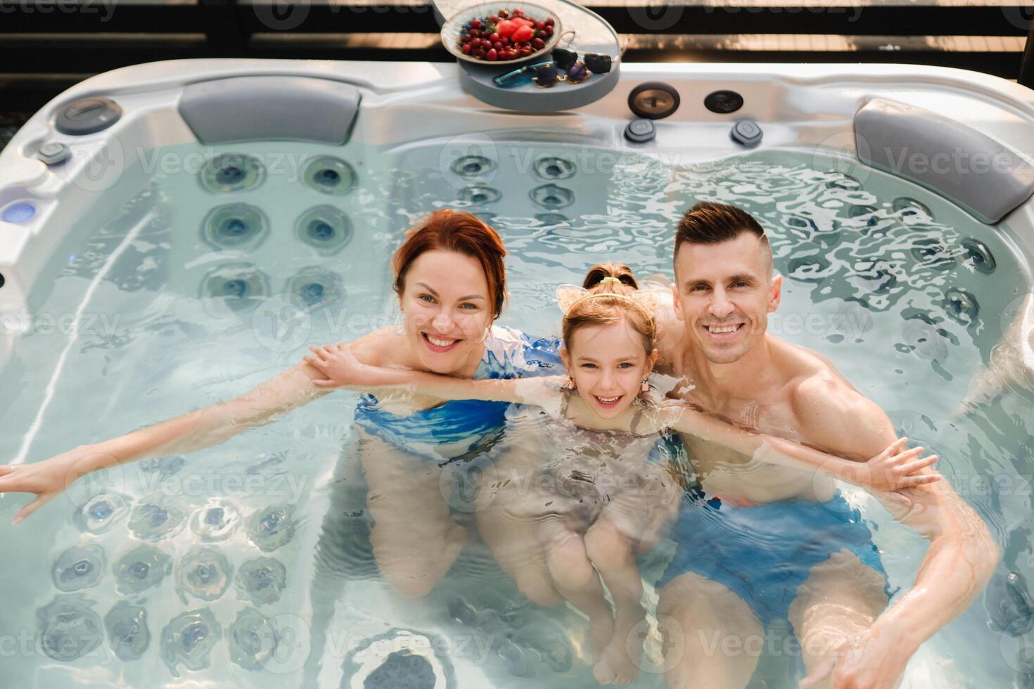 In summer, the family rests in the outdoor hot tub photo