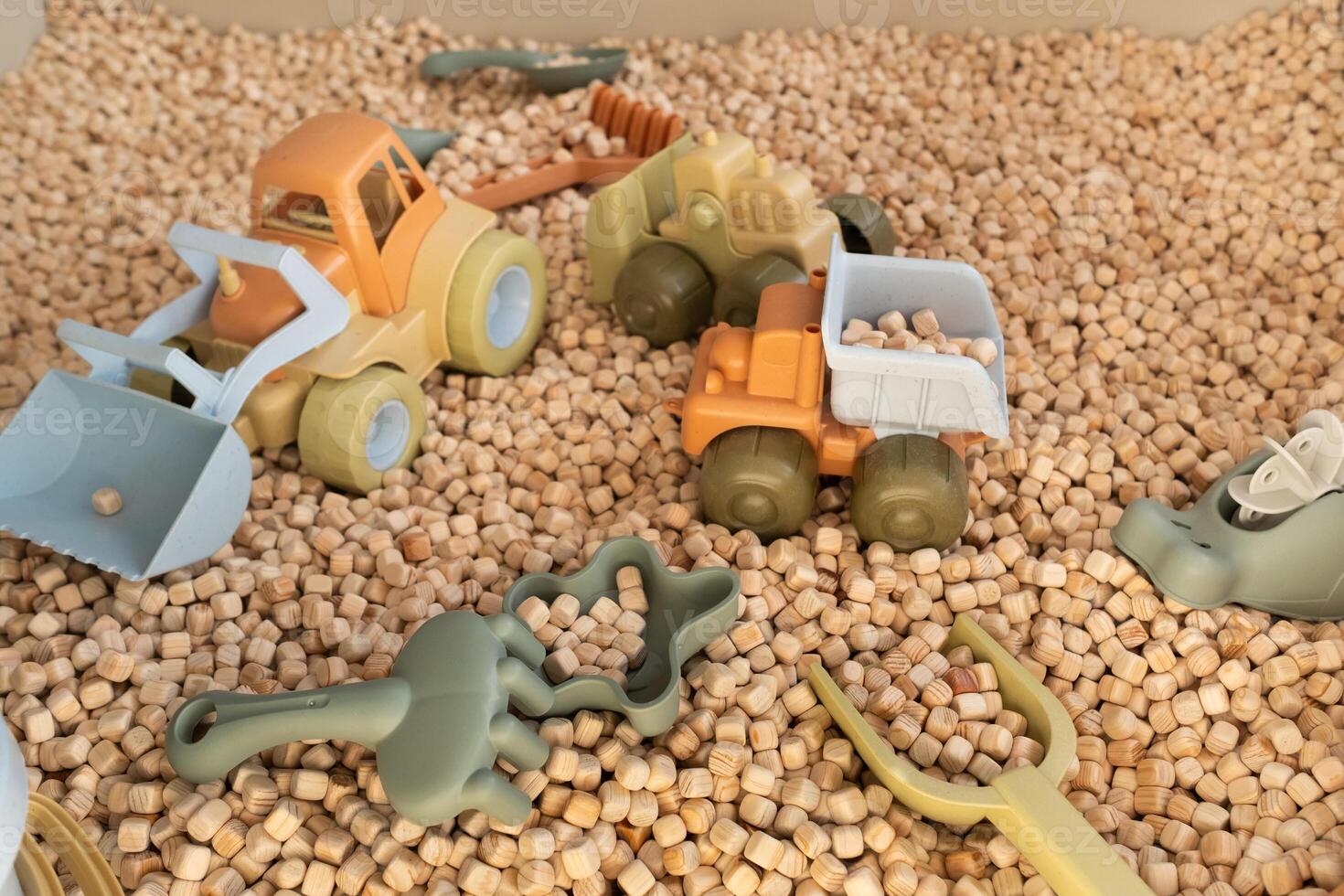 A modern children's sandbox with toys. Sandbox filler in the form of wooden small wooden cubes photo