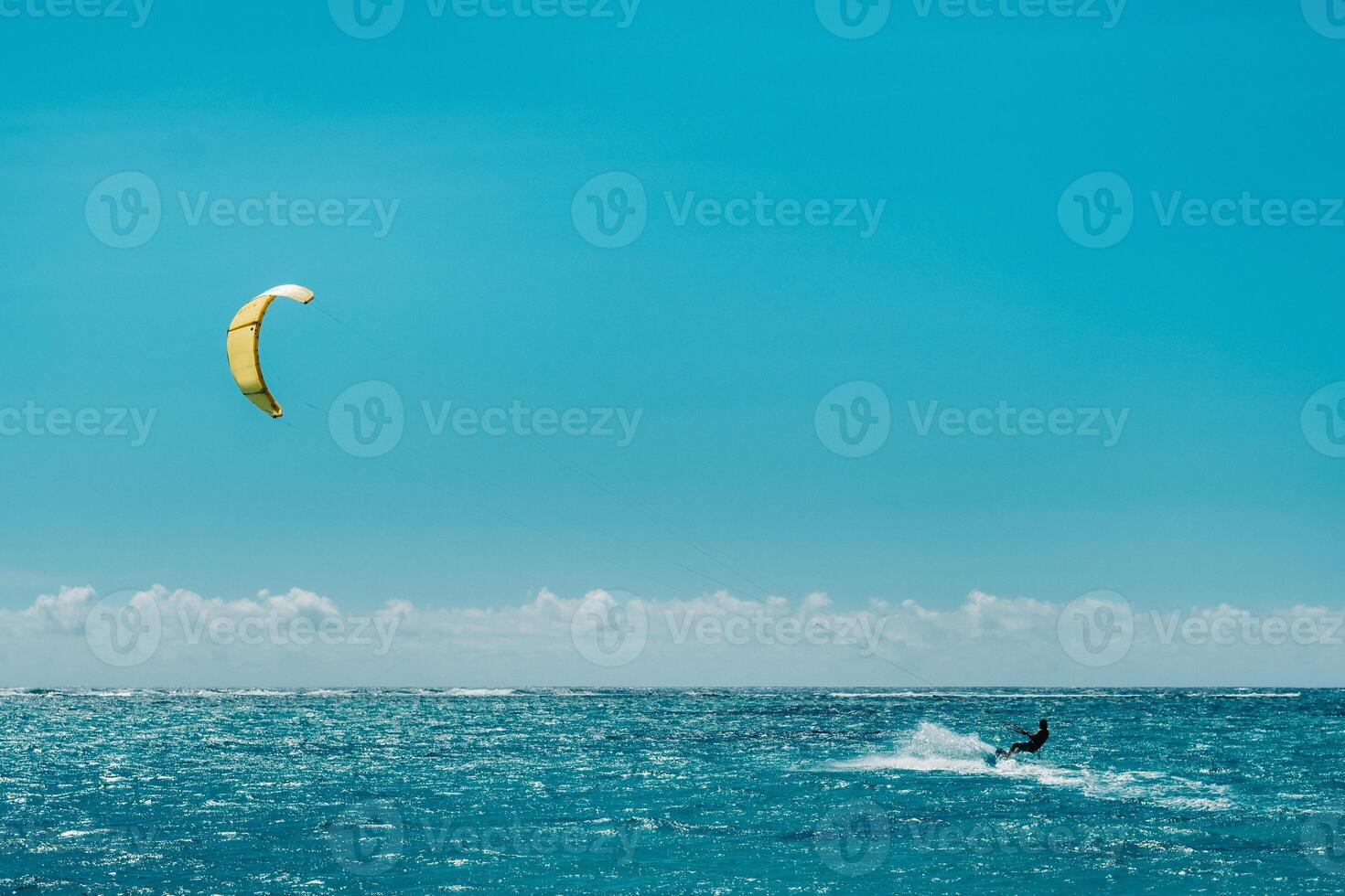 A man paragliding on Le Morne beach, Mauritius, Indian ocean on the island of Mauritius photo