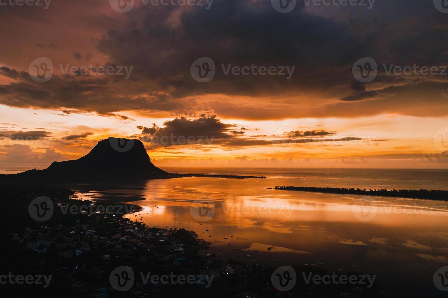 Aerial view with ocean at warm sunset time and Le Morn mountain in Mauritius. photo