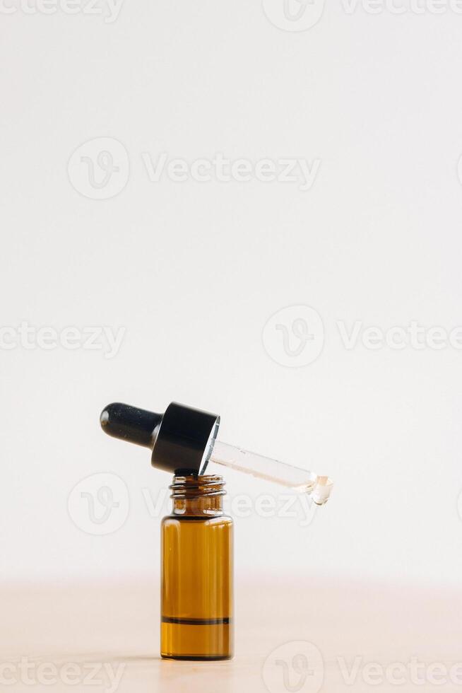 Essential oil in one bottle standing on the surface photo