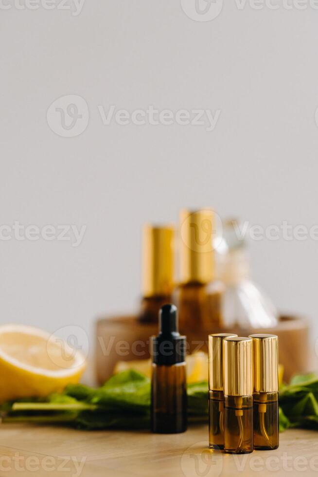 esencial petróleo en botellas con limón y menta fragancia acostado en un de madera superficie foto