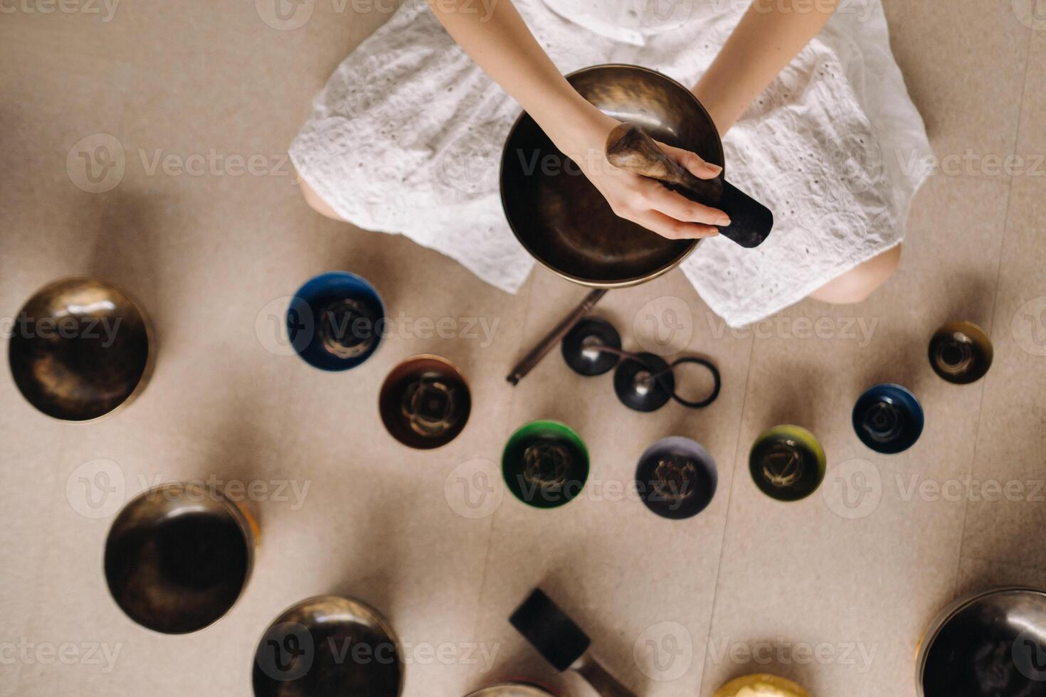 Close-up of a Tibetan singing bowl in your hands - Translation of mantras transform your impure body, speech and mind into a pure exalted body, speech and mind of a Buddha photo