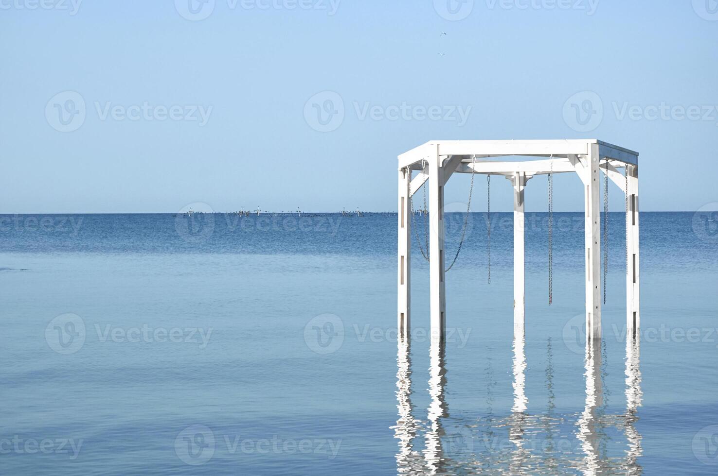 Wooden white arches on the beach. Summer vacation photo