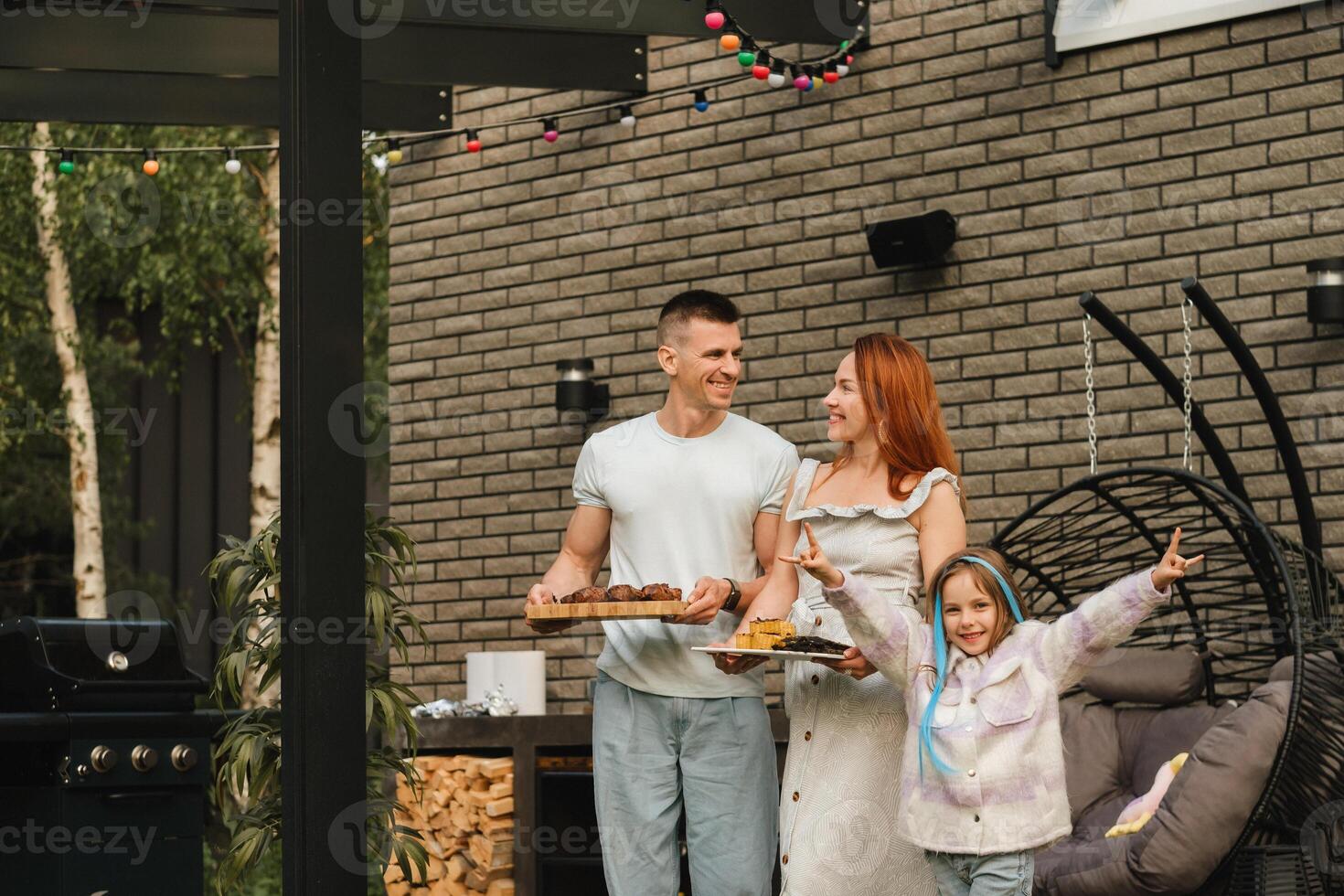 A happy family has prepared lunch and will eat at their house. Portrait of a family with food in their hands photo