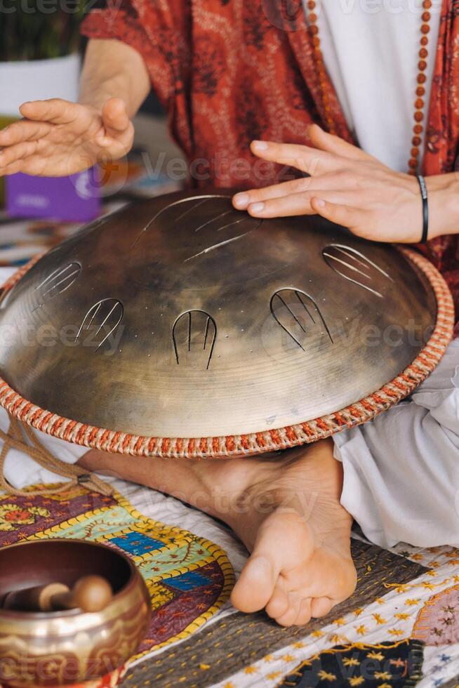 Close-up of a man's hand playing a modern musical instrument, the orion reed drum photo