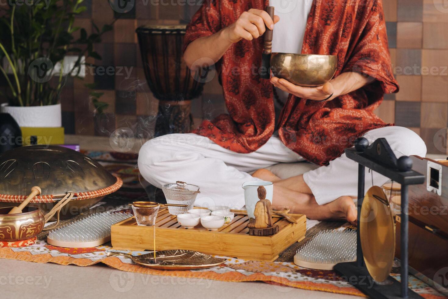 tibetano canto cuenco en el manos de un hombre durante un té ceremonia foto