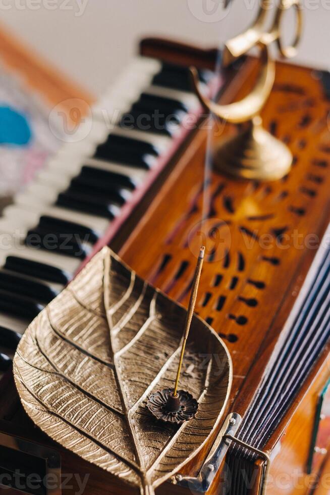 harmonium during the practice of kundalini yoga and the incense standing on it photo